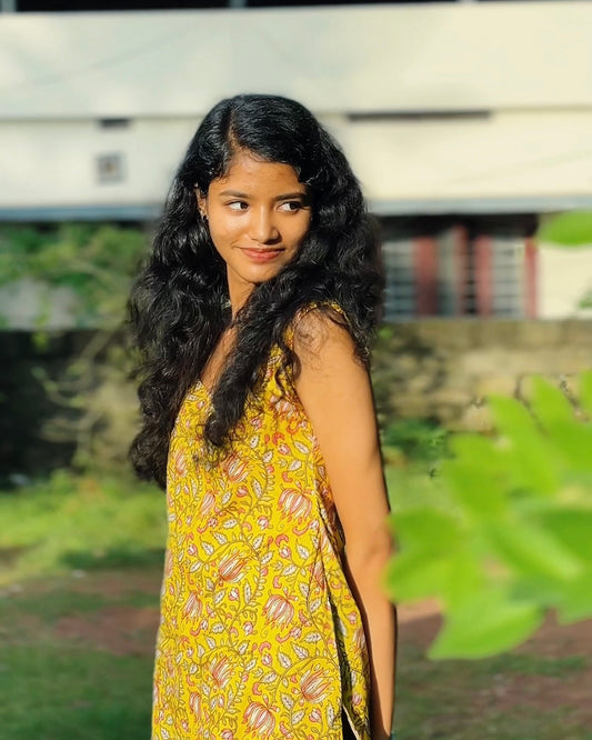 Bright yellow base with multicoloured floral prints (primarily pink, white, and green).