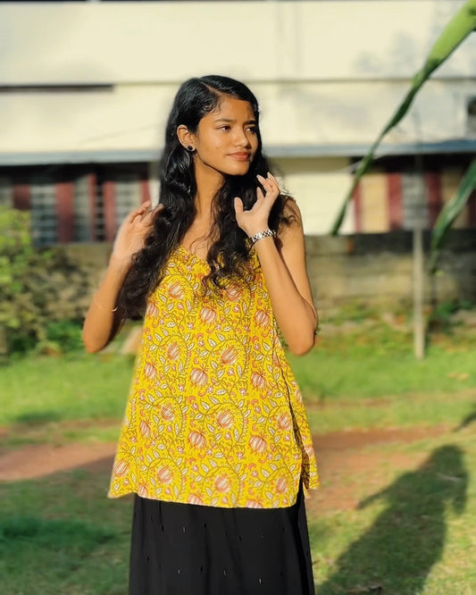Bright yellow base with multicoloured floral prints (primarily pink, white, and green).